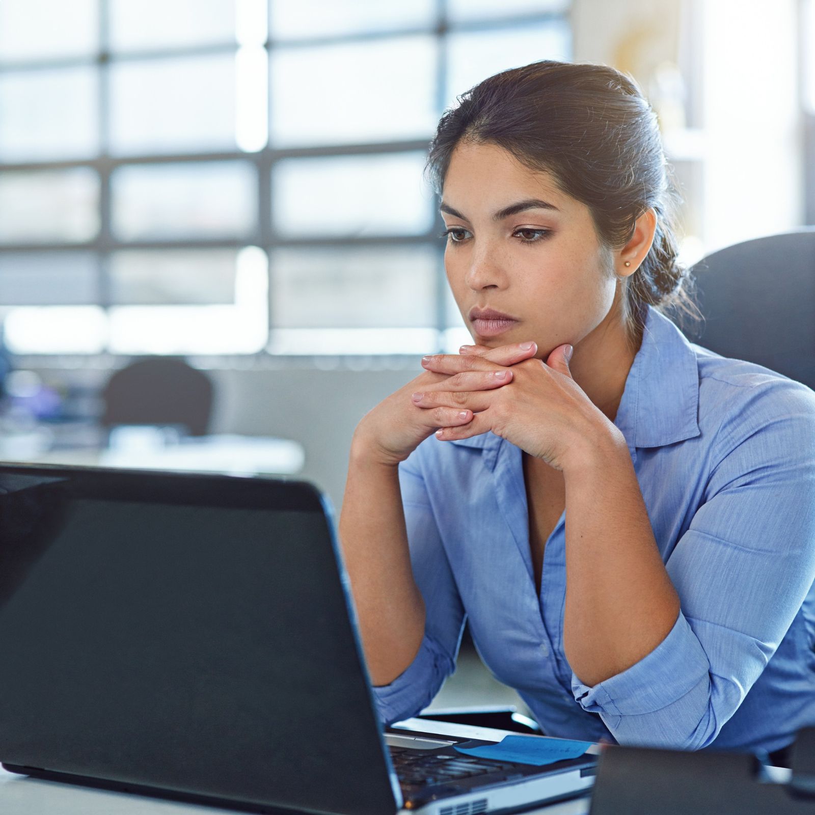 Businesswoman working with focus at a laptop